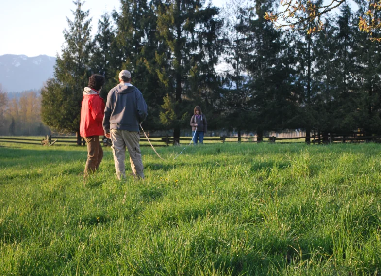Open grass field with people standing around